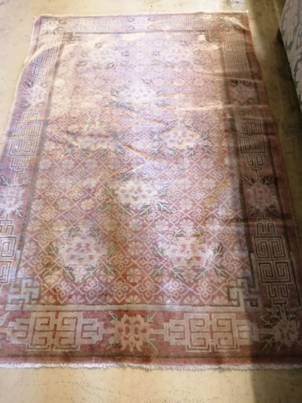 A Chinese rust ground rug, woven with a trellis pattern of scrolling foliage, 120 x 180cm
